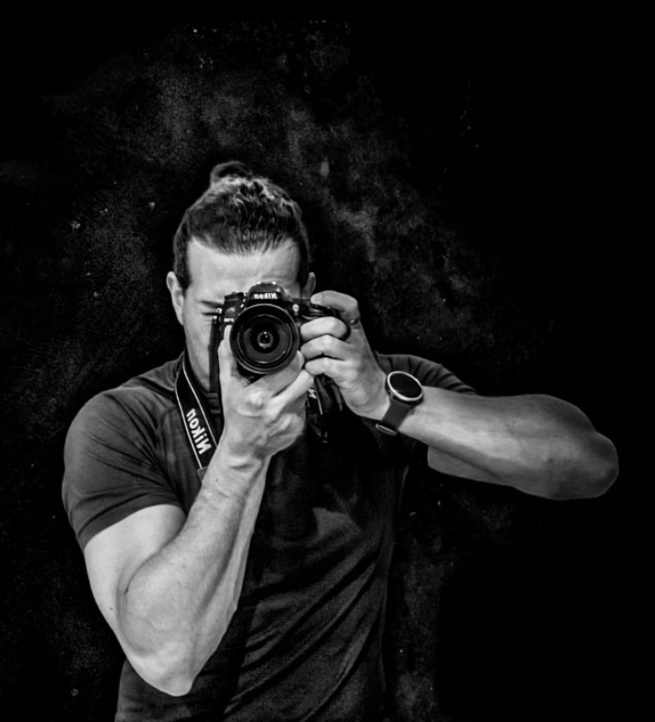 Greg holding a camera, self-portrait